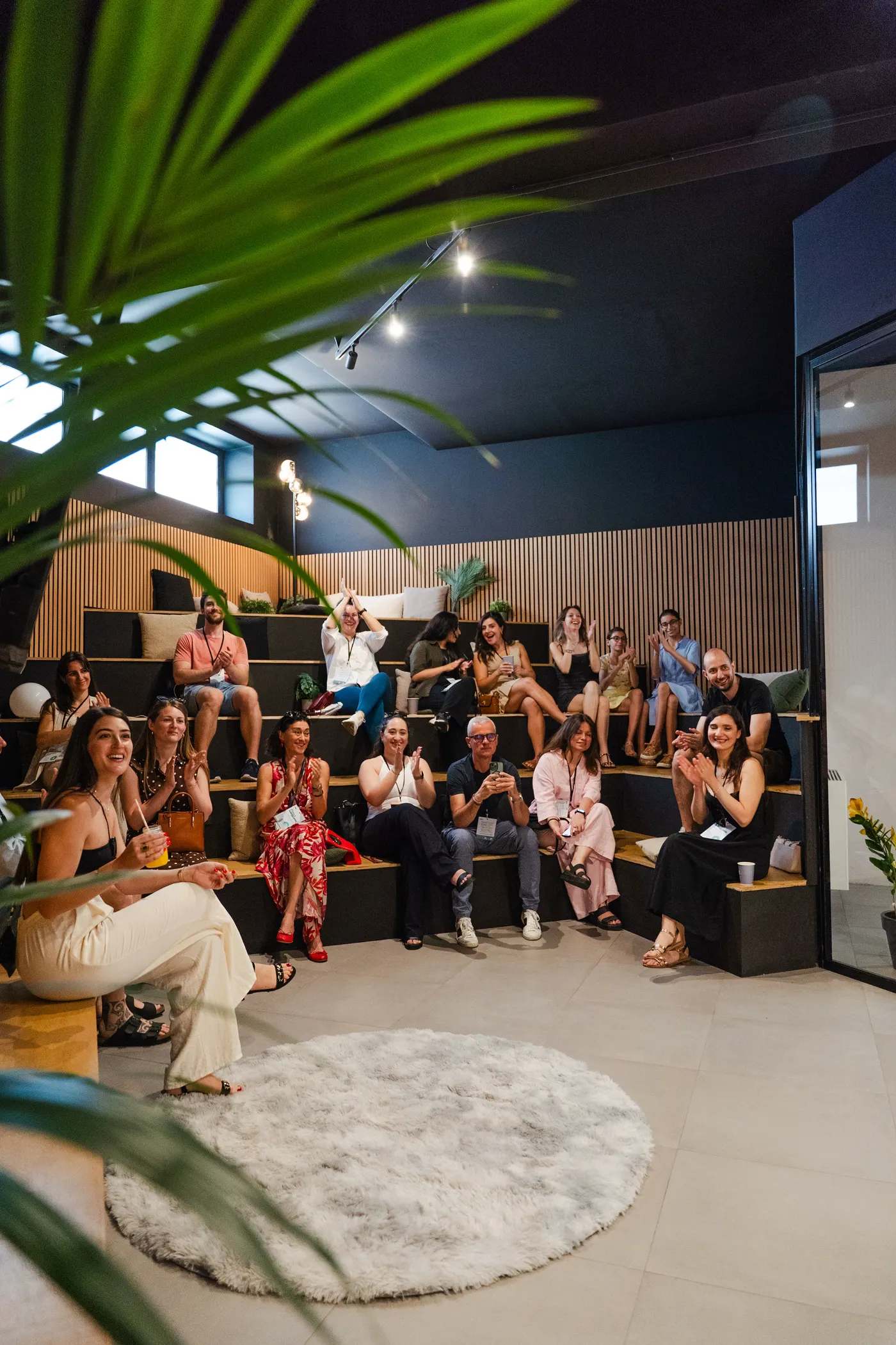A live audience seated on tiered benches at a Feat.House recording